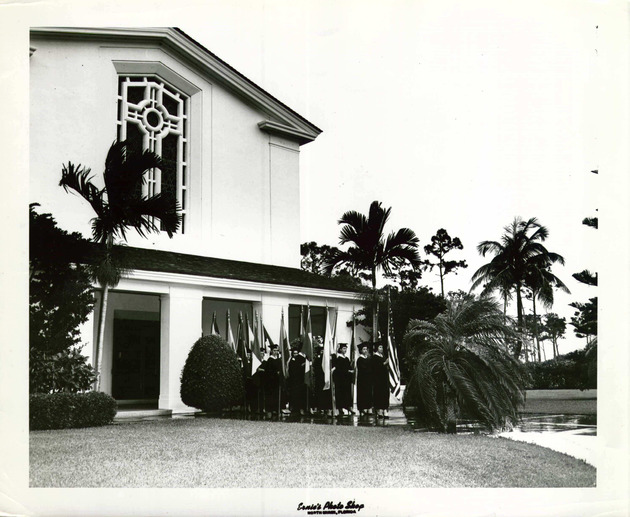 Students holding international flags leave Cor Jesu Chapel